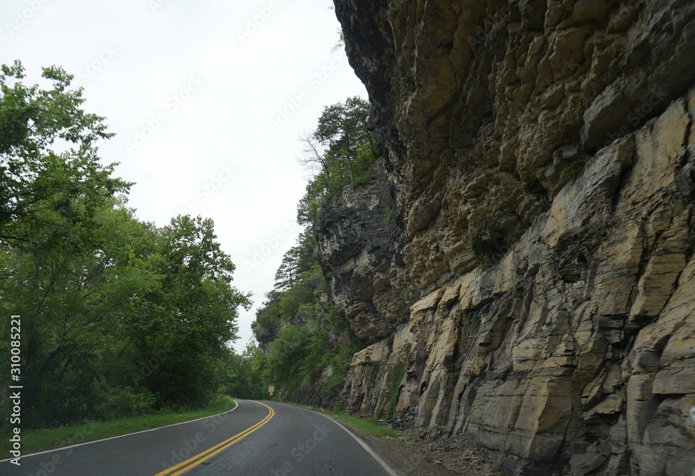 Scenic drive on a winding road with rock walls
