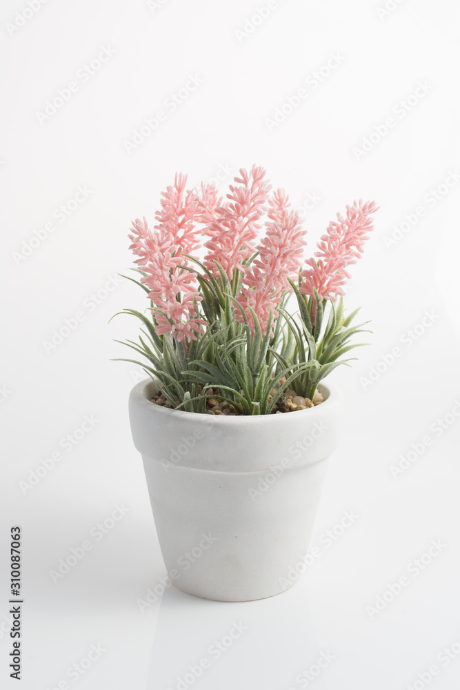 Pink Artificial flowers in pot white background Pink Artificial flowers in pot white background