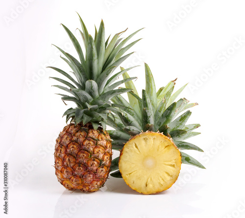 Full pineapple and cut inside white background