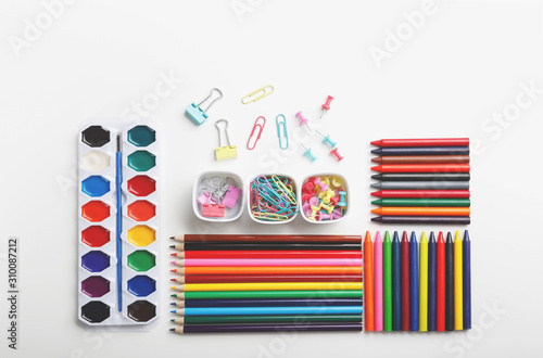 Colorful art supplies organized on a white background