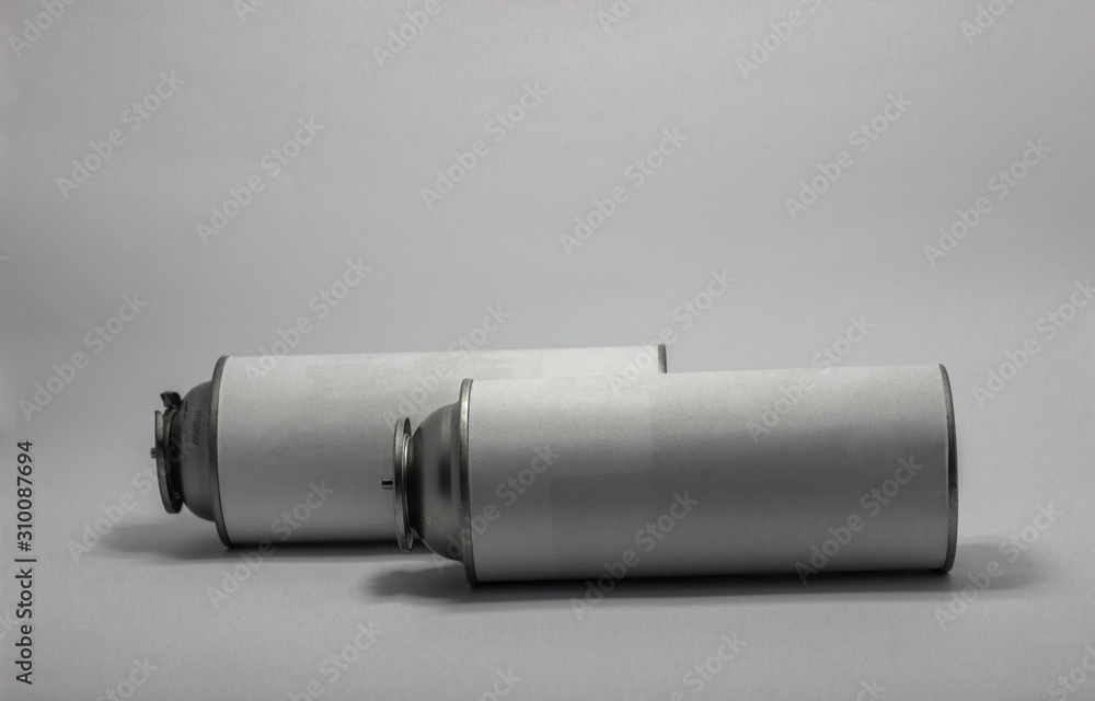 White portable tourist gas cylinder for burners with a white background. White portable tourist gas cylinder for burners with a white background.