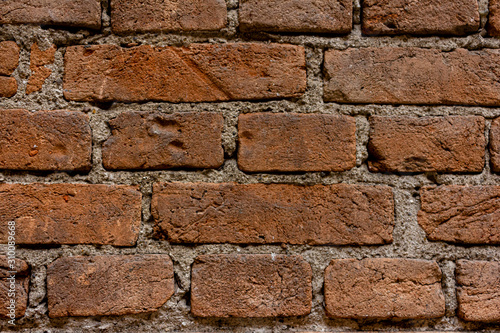 Wall of bricks. Brick worn by time.