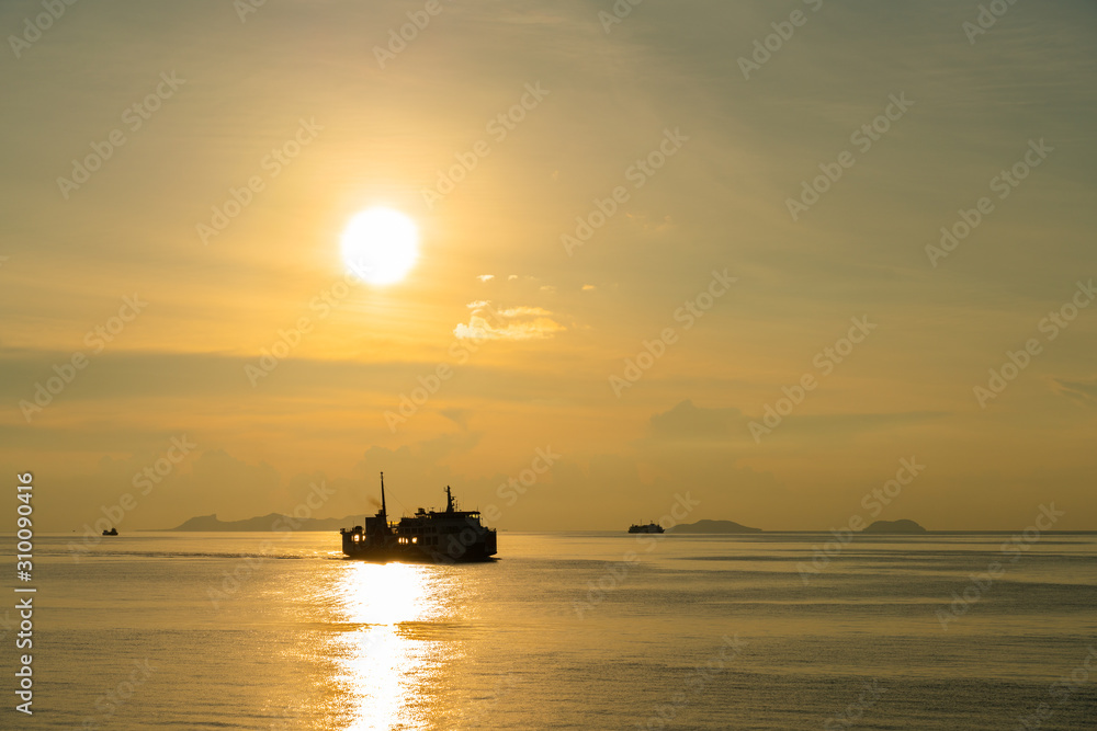 SIlhouette unidentified ferry ship running sea