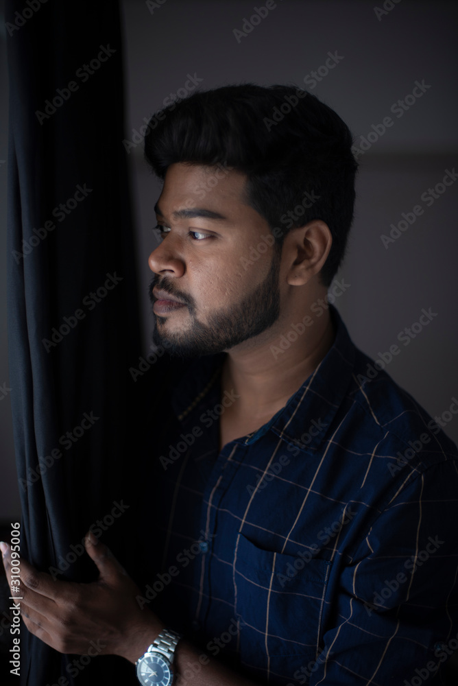 an young tall, dark and handsome Indian Bengali man in a blue shirt standing in white studio background. Indian lifestyle and fashion. an young tall, dark and handsome Indian Bengali man in a blue shirt standing in white studio background. Indian lifestyle and fashion.
