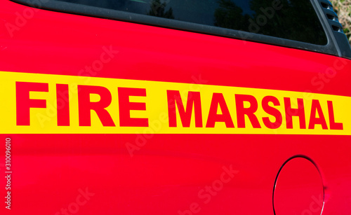 Fire Marshal sign on side of red fire engine vehicle