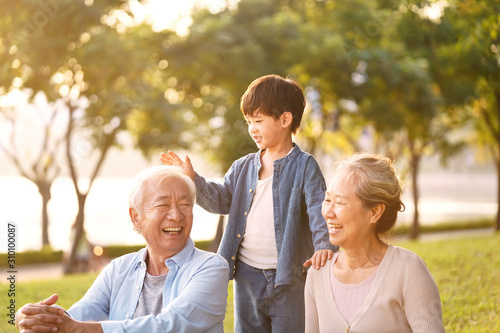 asian grandparents enjoying good time with grandson photo