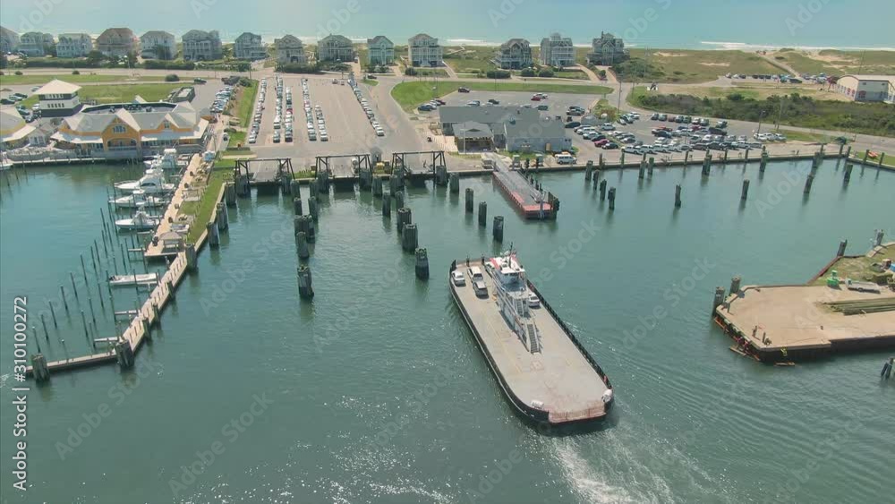 Aerial: Car ferry entering port in the town of Hatteras. Outer banks, North Carolina, USA. 10 August 2019 Aerial: Car ferry entering port in the town of Hatteras. Outer banks, North Carolina, USA. 10 August 2019