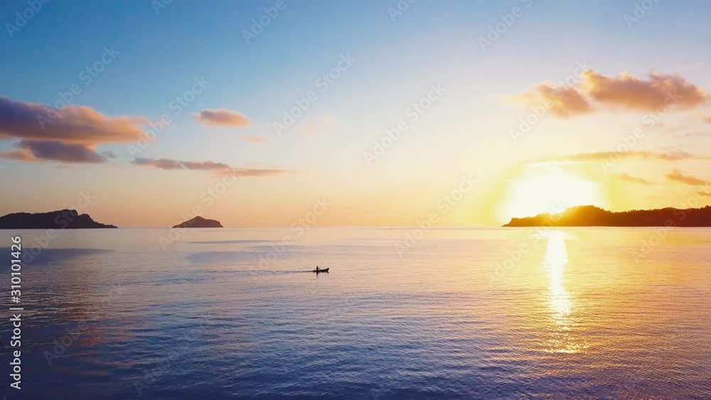 Fisherman paddling back home during sunset after a long day of fishing in the Comoros, Africa. Fisherman paddling back home during sunset after a long day of fishing in the Comoros, Africa.