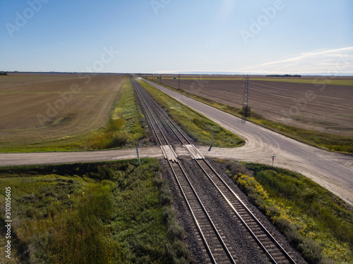 Aerial View of Double Train Tracks Across Prairie