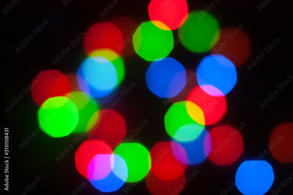 Abstract unfocused background - colorful bokeh of different bubbles on a black background. Modern blurred pattern for design and for Christmas, New year and funny holiday backdrops.. Abstract unfocused background - colorful bokeh of different bubbles on a black background. Modern blurred pattern for design and for Christmas, New year and funny holiday backdrops..