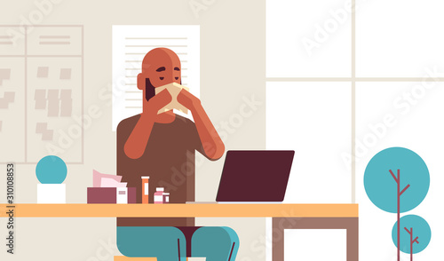 sick businessman blowing nose with handkerchief african american guy sitting at workplace using laptop man having flu sneeze illness concept modern office interior portrait horizontal vector