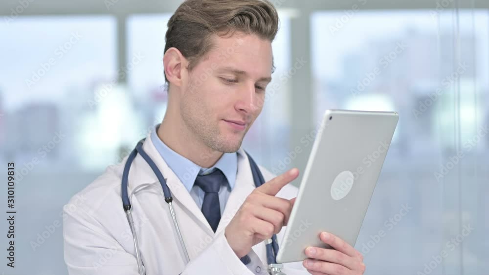 Portrait of Serious Young Male Doctor Using Tablet Portrait of Serious Young Male Doctor Using Tablet