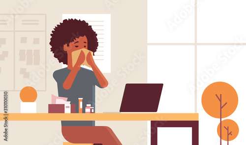 sick businesswoman blowing nose with handkerchief african american girl sitting at workplace using laptop woman having flu sneeze illness concept modern office interior portrait horizontal vector