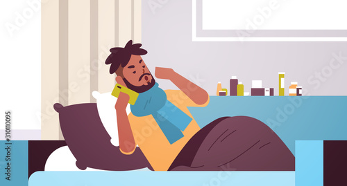 sick man having sneeze unhealthy african american guy in scarf calling phone for medical help suffering from cold flu virus illness concept modern living room interior closeup horizontal vector