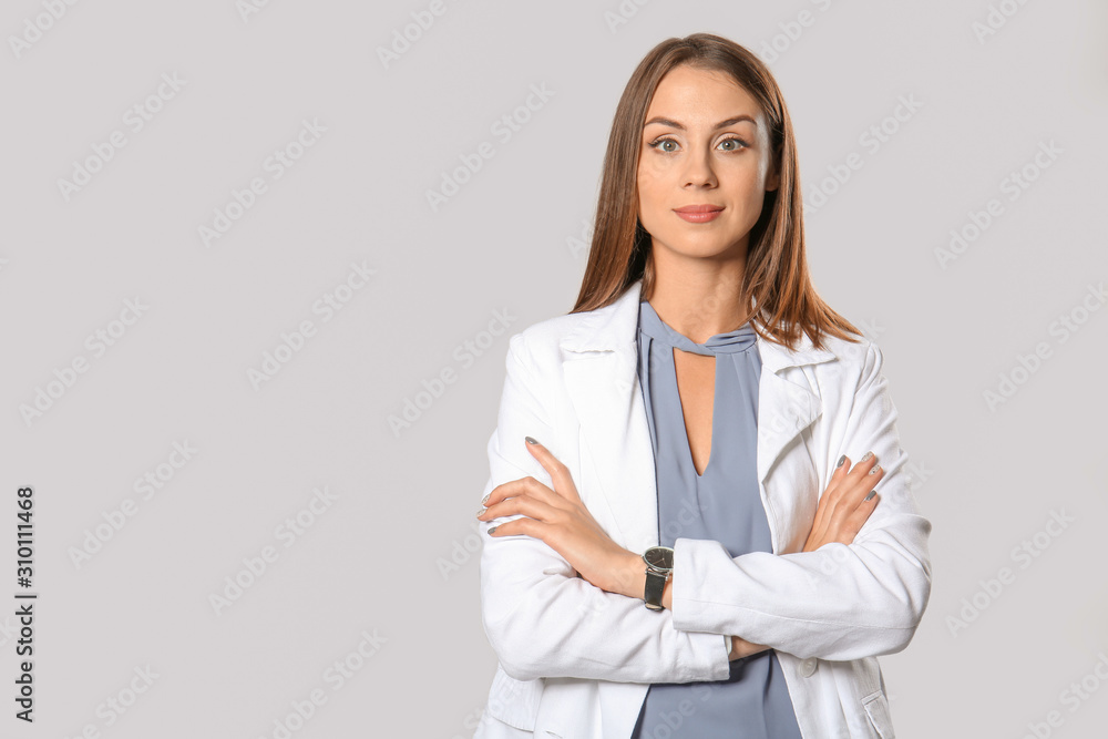 Beautiful young businesswoman on grey background Beautiful young businesswoman on grey background