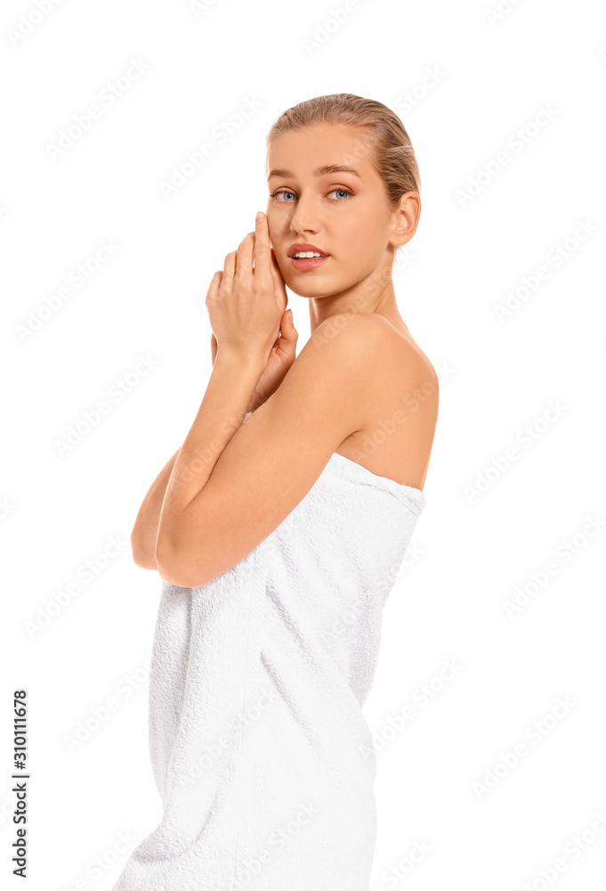 Beautiful young woman wrapped in towel on white background Beautiful young woman wrapped in towel on white background