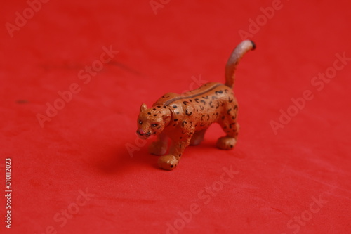 plastic toy with leopard shape in color background