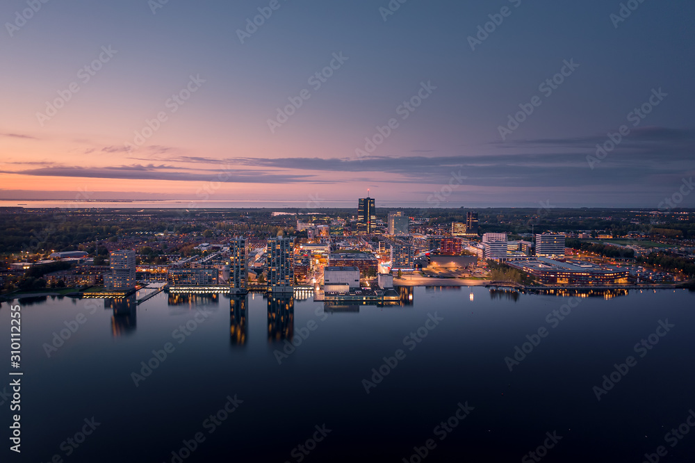 Almere city center illuminated at dusk. Aerial view.