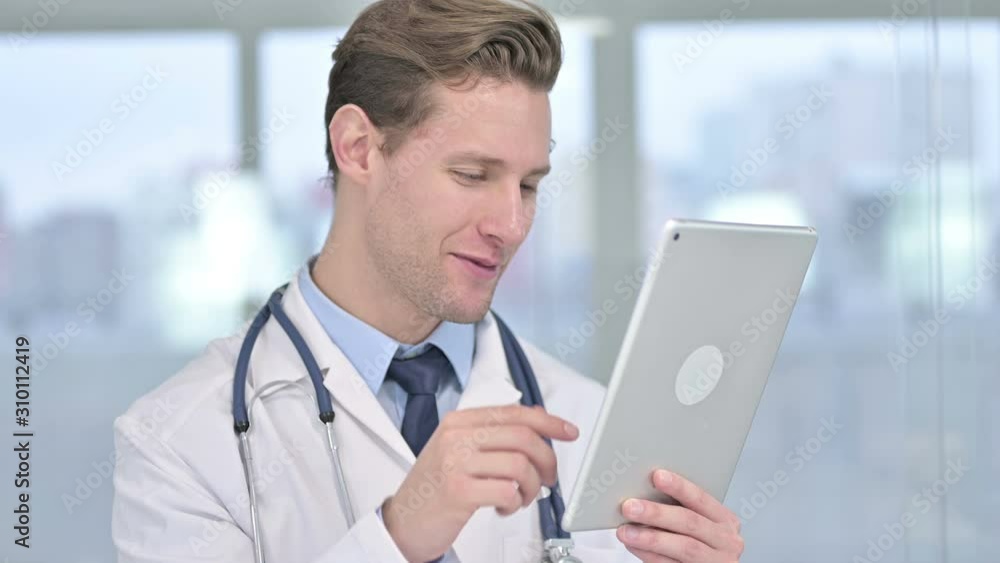 Portrait of Cheerful Young Male Doctor doing Video Chat on Tablet Portrait of Cheerful Young Male Doctor doing Video Chat on Tablet