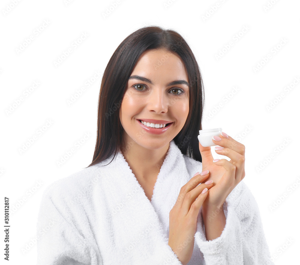 Beautiful young woman in bathrobe and with cream on white background Beautiful young woman in bathrobe and with cream on white background