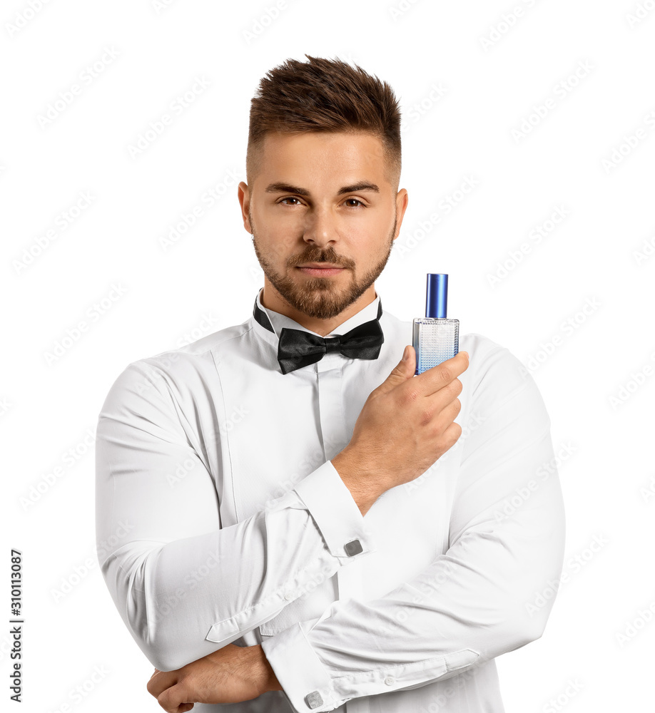 Handsome young man with bottle of perfume on white background Handsome young man with bottle of perfume on white background
