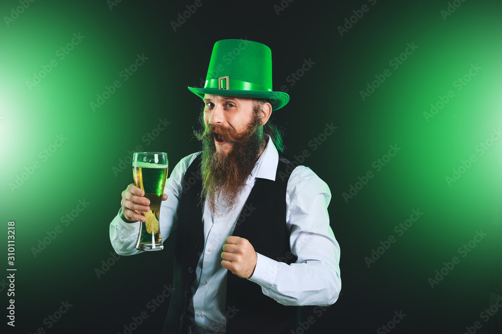 Bearded man with glass of beer on dark background. St. Patrick's Day celebration Bearded man with glass of beer on dark background. St. Patrick's Day celebration