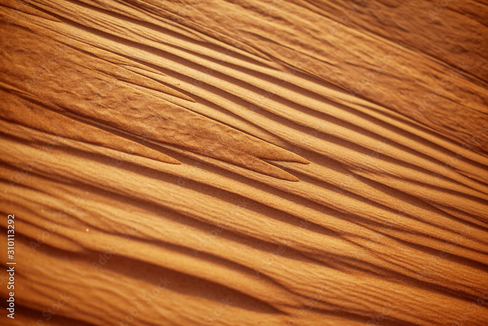 Wavy sandy texture on the dunes in the desert close-up. View from above Wavy sandy texture on the dunes in the desert close-up. View from above