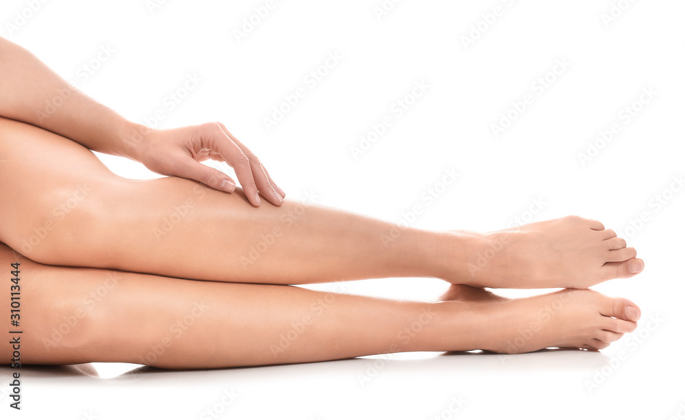 Legs of beautiful young woman on white background