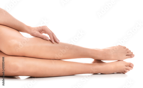 Legs of beautiful young woman on white background