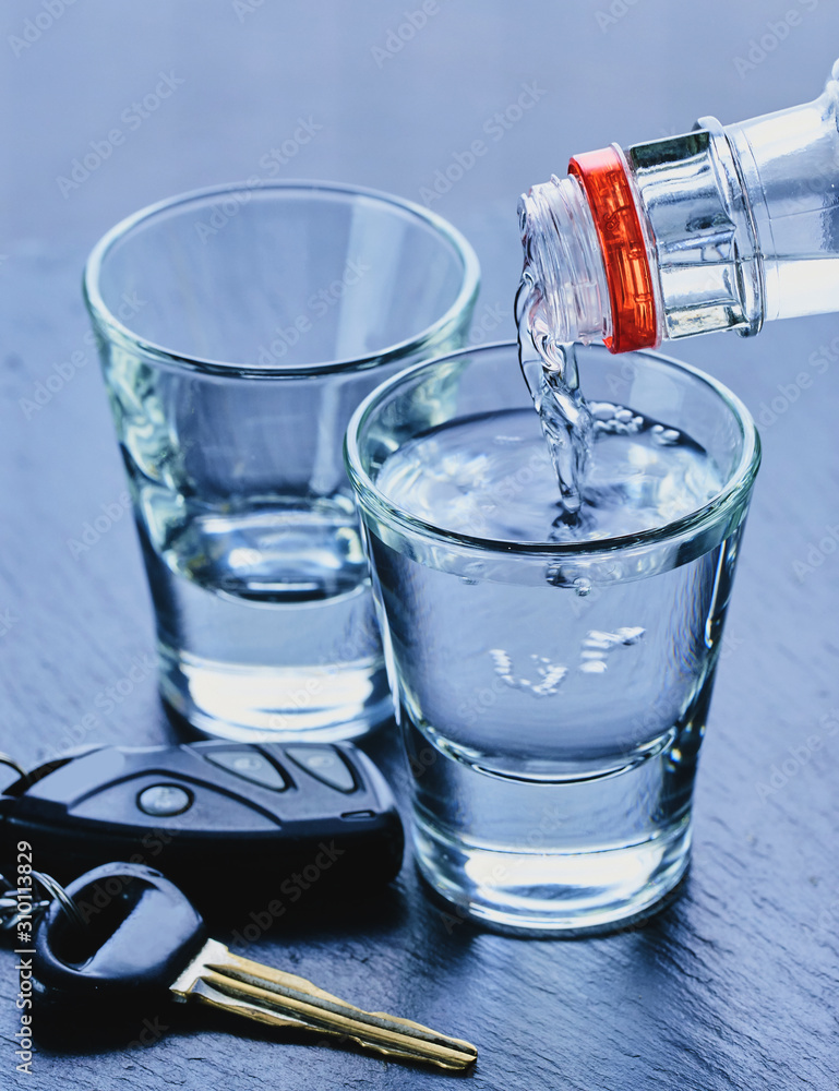alcohol is poured into glasses and car keys alcohol is poured into glasses and car keys