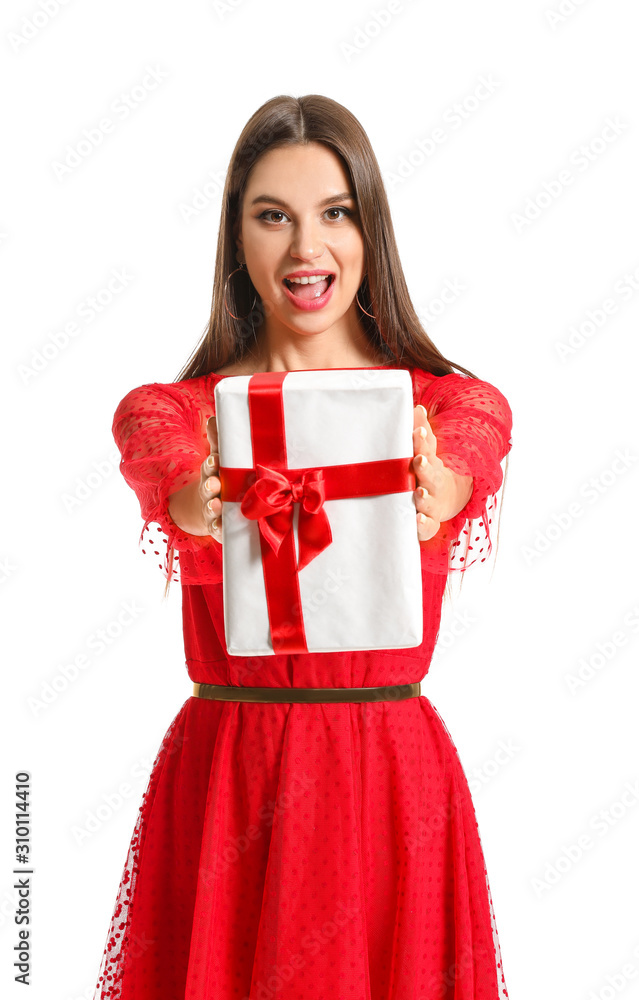 Fototapeta premium Beautiful young woman with Christmas gift on white background