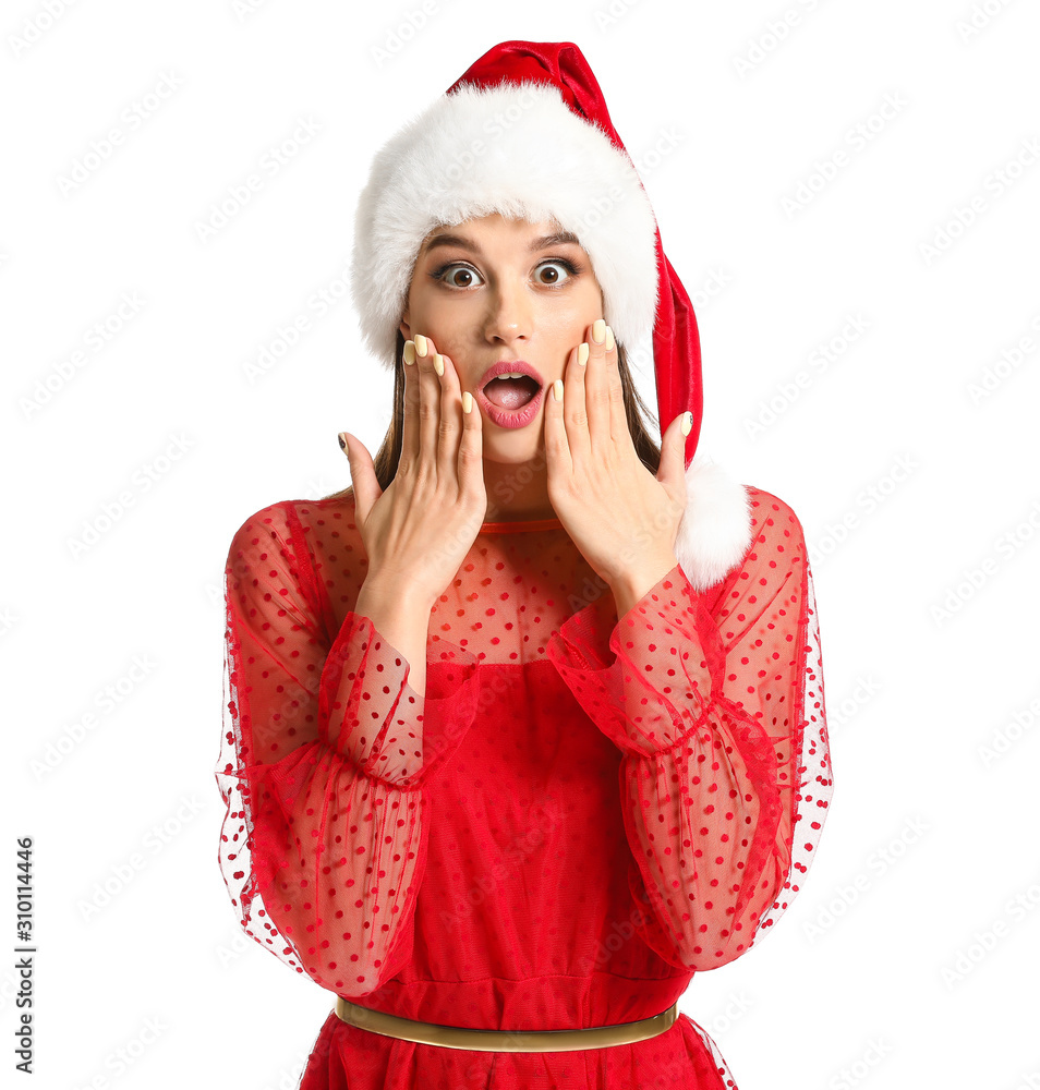 Surprised young woman in Santa hat on white background Surprised young woman in Santa hat on white background