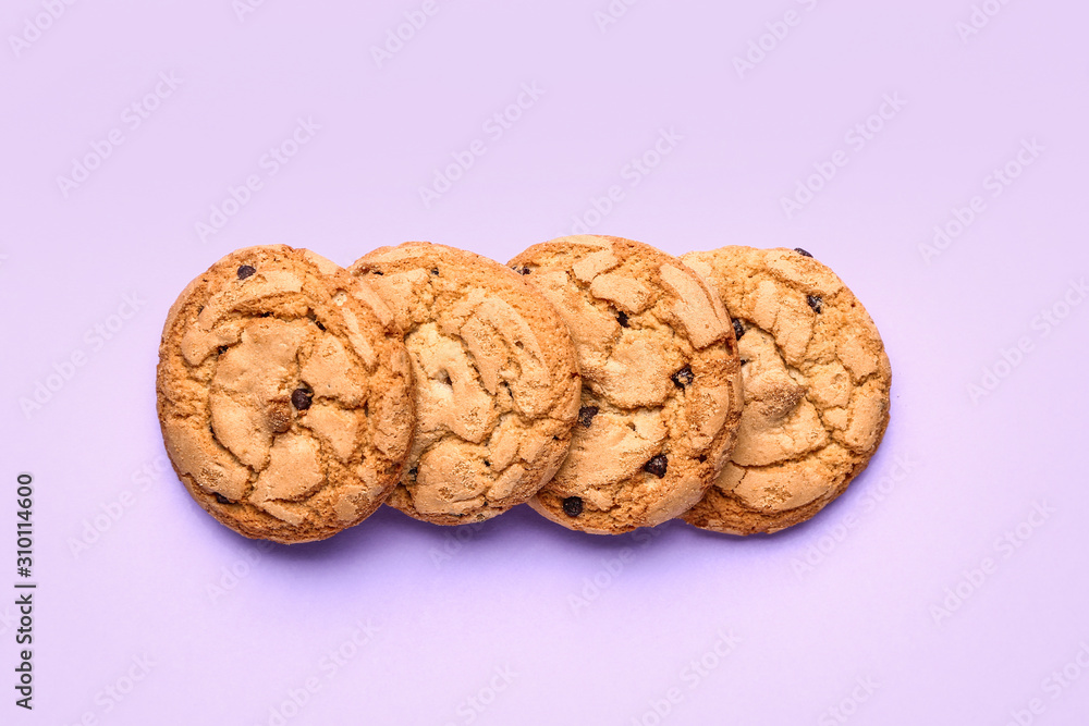 Tasty cookies with chocolate chips on color background Tasty cookies with chocolate chips on color background