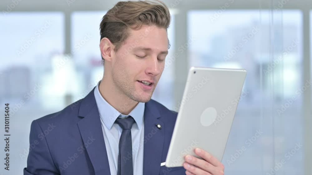 Portrait of Attractive Young Businessman doing Video Chat on Tablet Portrait of Attractive Young Businessman doing Video Chat on Tablet