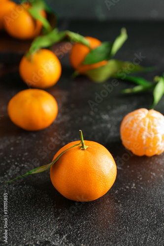 Sweet tangerines on dark table
