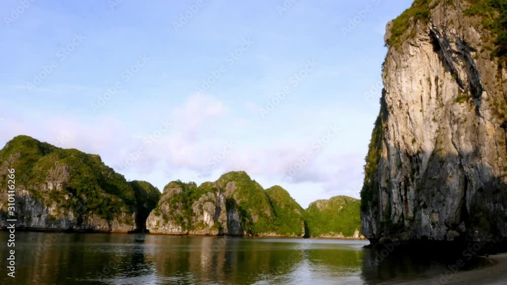 Ha Long Bay, Vietnam - The Fascinating Natural Rock Formation By The Water With Green Growing On Top - Time Lapse Ha Long Bay, Vietnam - The Fascinating Natural Rock Formation By The Water With Green Growing On Top - Time Lapse