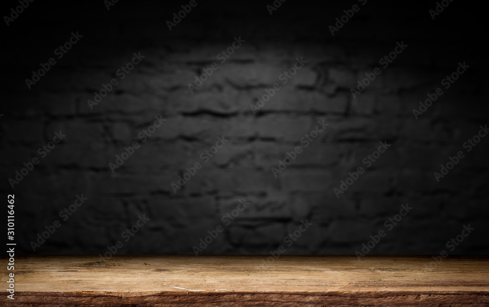 Wood table in front of rustic brick wall blur background with empty copy space on the table for product display mockup. Retro design montage presentation. Wood table in front of rustic brick wall blur background with empty copy space on the table for product display mockup. Retro design montage presentation.