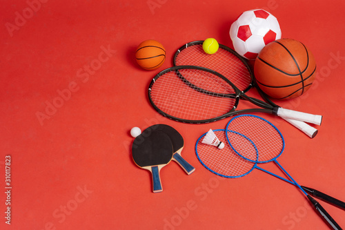 Sport equipment flat lay. Variety of rackets and balls