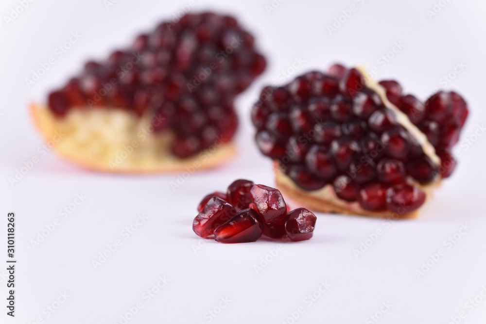 Pomegranate seeds on the white background close up Pomegranate seeds on the white background close up