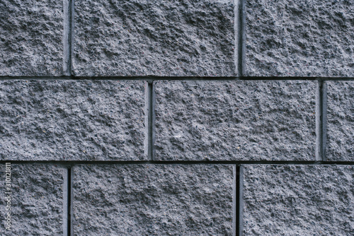 Grey brick stone, pattern wall background, close up, flat position, top front view.