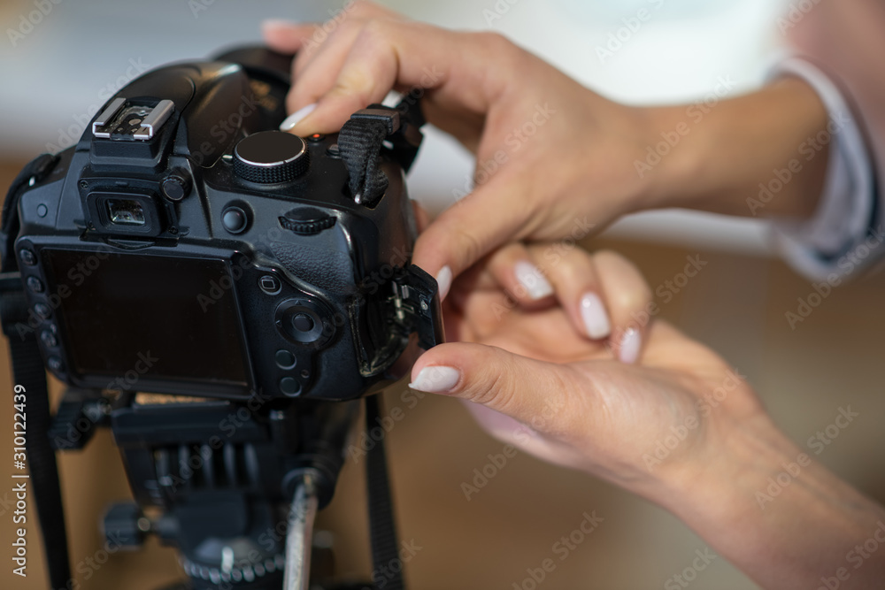 Close up of female hands setting up the camera