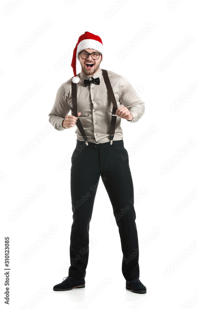 Handsome young man in Santa Claus hat on white background Handsome young man in Santa Claus hat on white background