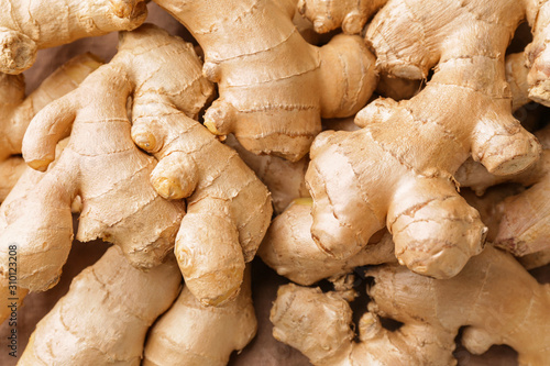Naklejka Fresh raw ginger as background