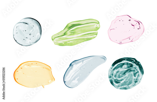 Set of cosmetic gel, serum swatches isolated on white background. Different colored transparent skincare product smear smudge sample collection. Liquid cream with bubbles texture