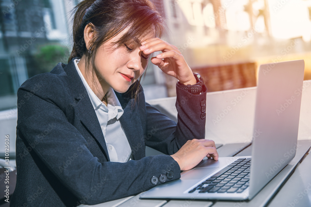 Asian business woman feeling bad migraine headache when reading bad news business report fail from laptop email. Asian business woman feeling bad migraine headache when reading bad news business report fail from laptop email.