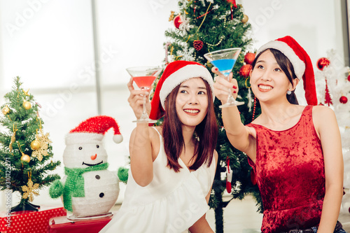 Asian cute girl teen party drinking in Christmas New year eve together happy enjoy and fun.