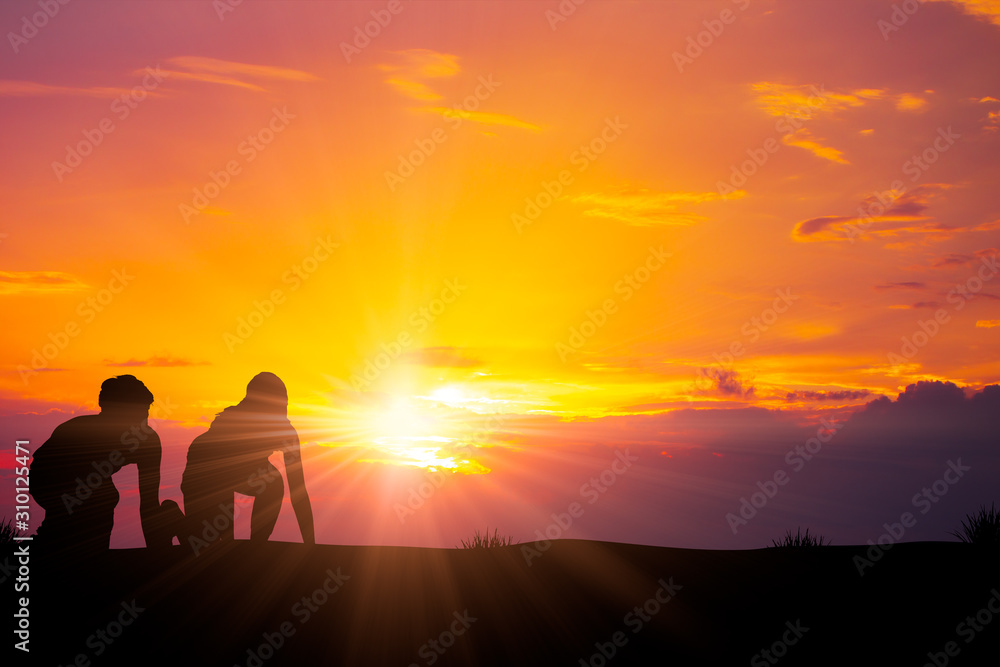 Silhouette of two runner ready to start to run with sunrise background for Startup and The Beginning concept with space for text.