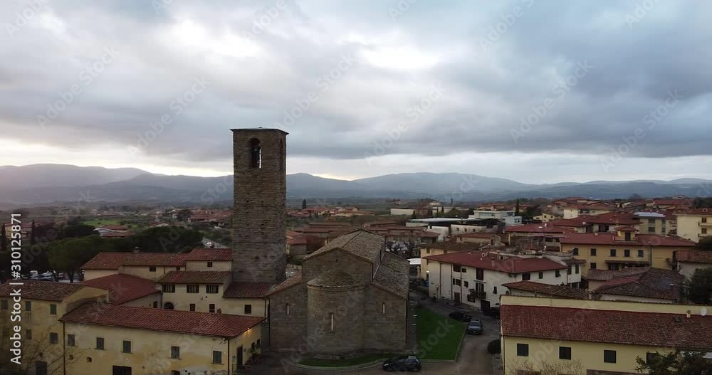 Aerial back view of Ancient roman entire stone church of Peter and Paul Saints at Cascia, Reggello containing famous italian Masaccio paintings. Tuscany, Italy. Cloudy winter day at sunset Aerial back view of Ancient roman entire stone church of Peter and Paul Saints at Cascia, Reggello containing famous italian Masaccio paintings. Tuscany, Italy. Cloudy winter day at sunset