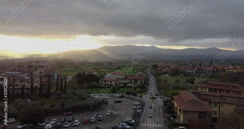 Sunset view of countryside area around roman entire stone church of Peter and Paul Saints at Cascia, Reggello containing famous italian Masaccio paintings. Tuscany, Italy. Cloudy winter day at sunset photo