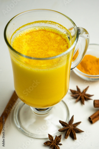 golden milk, with turmeric on white background